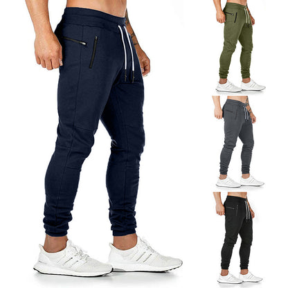 Men's drawstring track pants in navy, green, and gray colors, designed for comfort and performance.