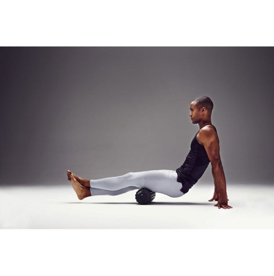 Man using the 4-Speed Vibrating Foam Roller for muscle recovery and performance enhancement.