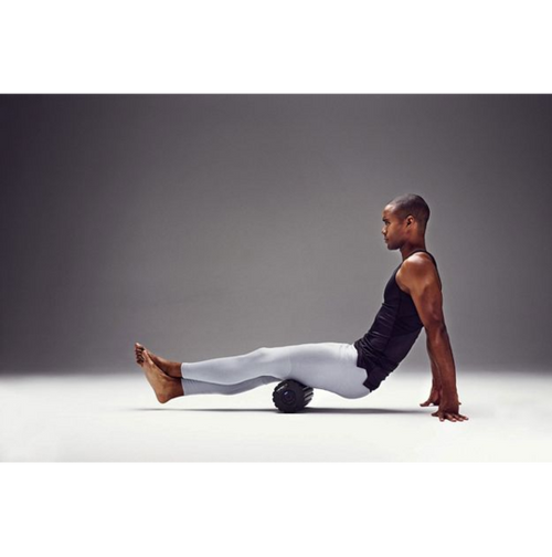 Man using the 4-Speed Vibrating Foam Roller for muscle recovery and performance enhancement.
