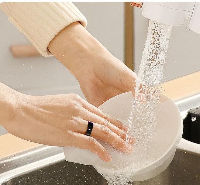Person washing a bowl while wearing a Smart Health Ring Bluetooth Black in a modern kitchen.