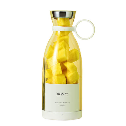 Portable electric mini juicer filled with fresh fruit, perfect for healthy living on the go.
