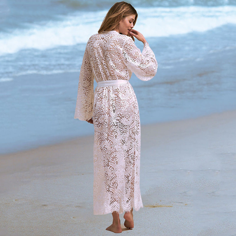 Women's Lace Beach Cover-Up Cardigan worn by a model on the beach, showcasing its lightweight and flowing design.
